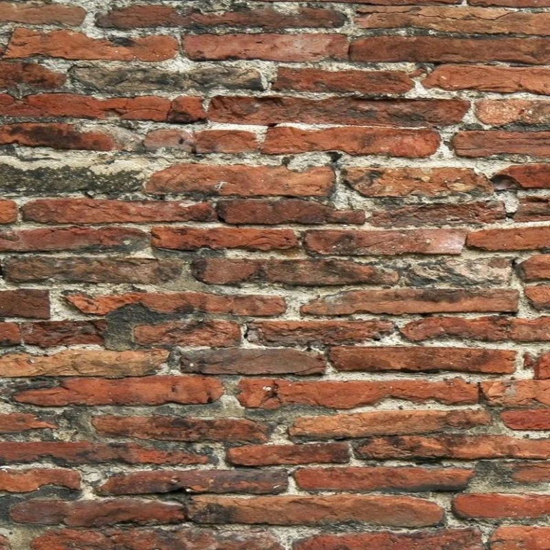 Nahaufnahme einer alten roten Ziegelsteinmauer mit rauer Struktur und Fugen